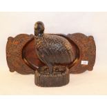 A carved wooden bird and platter