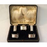 A cased silver five piece cruet,