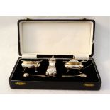 A cased silver three piece cruet,