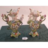 A pair of continental porcelain floral and cherub vases (one as found)