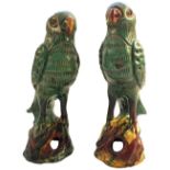 A pair of Chinese provincial green and polychrome parrots,