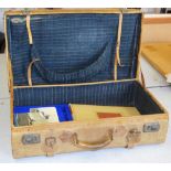 A pigskin suitcase containing books