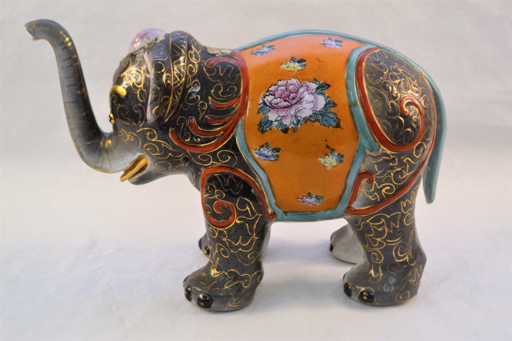 A Chinese pottery polychrome elephant (repaired trunk)