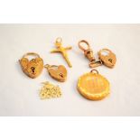 Three 9ct gold heart shaped padlocks (one as found), a circular 9ct gold photo locket (as found),