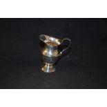 A silver cream jug,