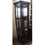 An unusual three tier hexagonal mahogany glass display cabinet