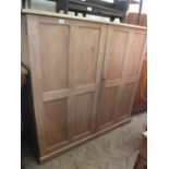 A large pine two door cupboard