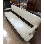 A long cream upholstered bench seat