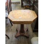 A Victorian octagonal walnut fitted work table on tapered column and platform base