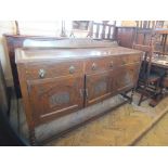 A 1920's oak sideboard on barley twist supports