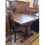 An oak draw leaf table and four chairs