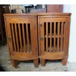 A pair of bow front pine bedside cabinets with slatted doors