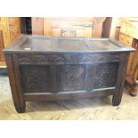 An 18th Century oak coffer with carved panel front