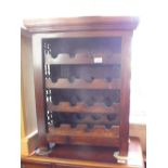 A mahogany and metal wire wine rack