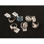 Six silver rings set with stones including topaz, pearl,