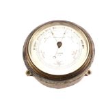 A circular metal cased barometer, signed Norie & Wilson, London No.