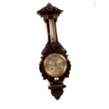 An aneroid barometer in heavily leaf carved oak case, signed Aitchison,