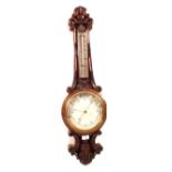 An aneroid barometer in heavily carved oak case (cracked glass)