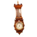 An aneroid barometer in carved oak case, signed B.