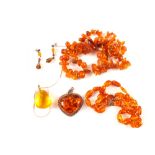 A mixed lot of amber jewellery including silver mounted heart shaped pendant,