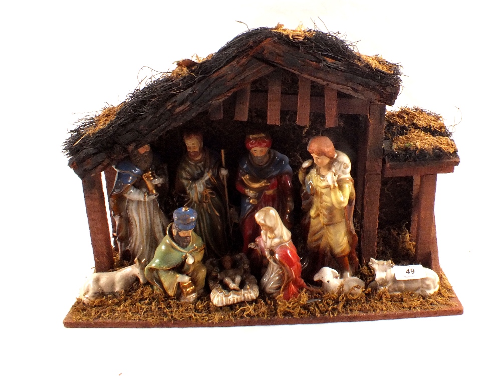 A porcelain and wooden nativity scene