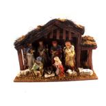 A porcelain and wooden nativity scene