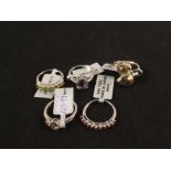 A group of five silver stone set rings including quartz, amethyst,
