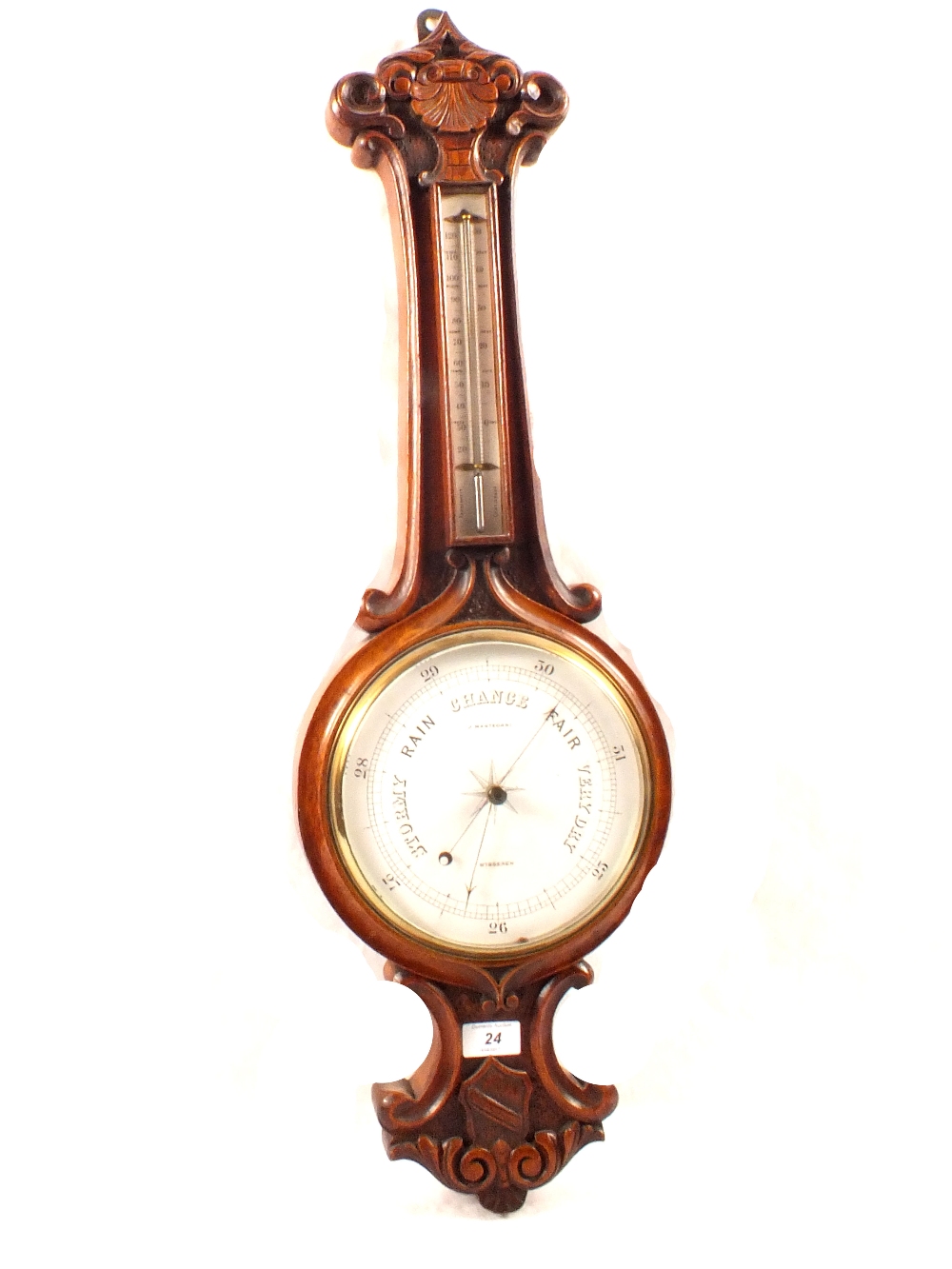 An aneroid barometer in shell and shield carved oak case, signed J.