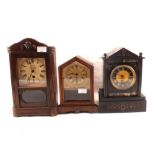 A black marble mantel clock plus two wooden cased German mantel clocks