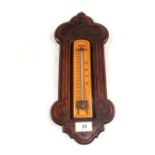 An oak cased fahrenheit thermometer with swan decoration