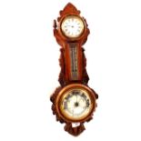 An aneroid barometer with clock in carved oak case (one hand detached)