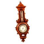An aneroid barometer in carved oak cased, signed Carter,