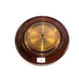 A circular oak brass dial barometer, signed Deacon & Sons,