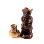 A 19th Century treacle glaze Toby jug and cover plus a 19th Century stoneware jug with hunting