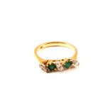 An 18ct gold emerald and diamond ring,