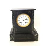 A black slate and marble mantel clock with key