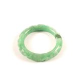 A carved Chinese apple green jade bangle