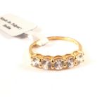 A 9ct gold ring set with five white stones