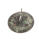 A 19th Century circular bronze sundial engraved with sun motif and inscribed 'Shadows Fall',