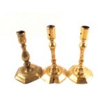 A pair of early 18th Century brass candlesticks on octagonal bases,