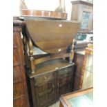 A 1950's two door cupboard, a mahogany oval gate leg table, a walnut hall table,