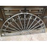 A semi circular decorative wrought iron wall mount