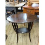 An Edwardian oval mahogany two tier occasional table