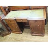 A Victorian mahogany three drawer pedestal desk with green leather top