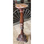 A mahogany torchere on reeded column