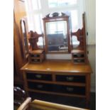 An Edwardian satinwood dressing table with two short and one long drawer in darker wood and three