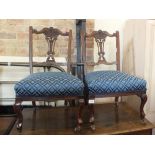 A pair of Edwardian mahogany carved back and blue upholstered dining chairs