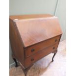 An inlaid mahogany two drawer bureau on cabriole legs