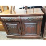 An Art Nouveau mahogany sideboard with two drawers and doors both carved