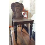 A Victorian mahogany carved back hall chair on reeded legs